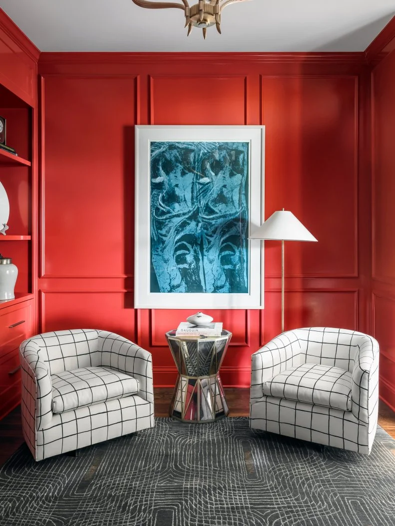 Red Home Library With Patterned Chairs and Oversized Art