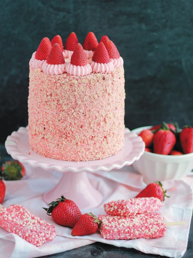 Pink strawberry shortcake ice cream bar cake topped with strawberries