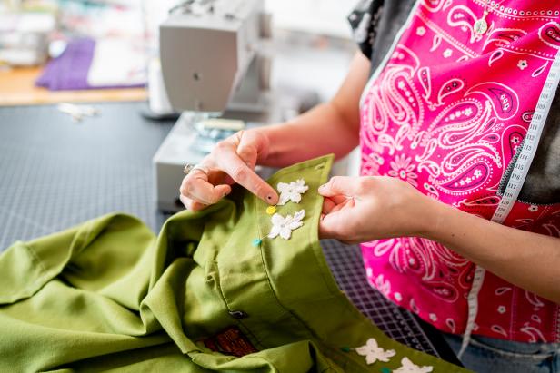 The crop top can be embellished with patches. Try several different layouts to get a feel for placement before making a final decision. Pin the patches in place to hold them steady while sewing them down.