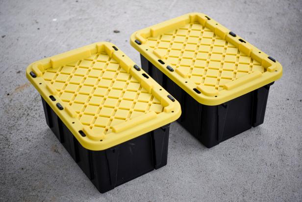 Two Black Bins With Yellow Tops