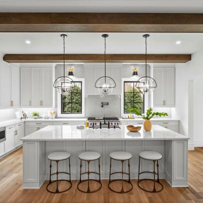 White Chef Kitchen With Wide Wood Beams