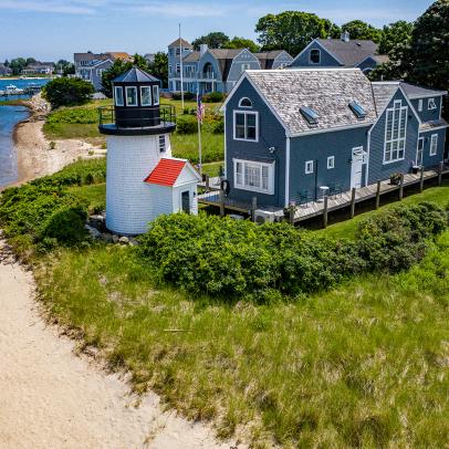 Blue Cape Cod House With White Lighthouse