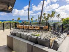 Deck Lounge Area With Black Railings Overlooking the Beach in Hawaii