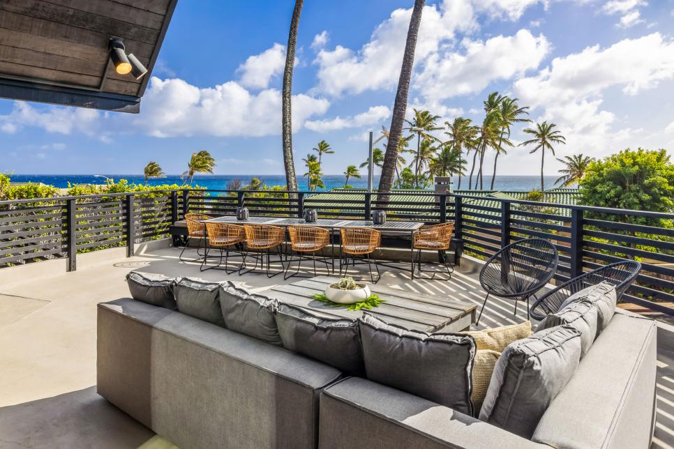 Deck Lounge Area With Black Railings Overlooking the Beach in Hawaii