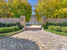 Stone Driveway Leading To French Country Home