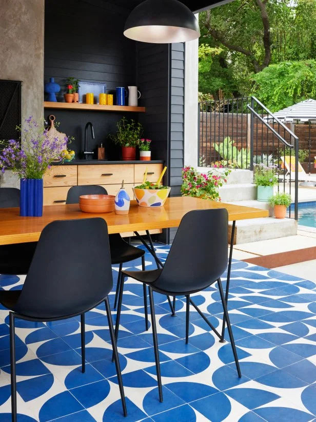 Outdoor Kitchen With Black Walls and a Blue Tile Floor