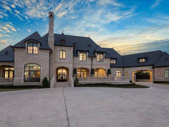 Tan Stone Mansion and Driveway