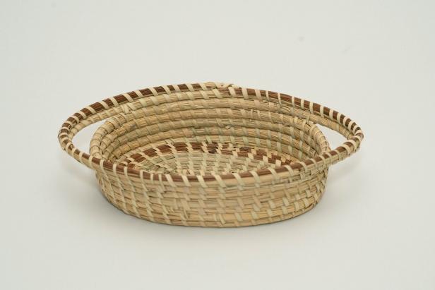 Sweetgrass Baskets are an African art form practiced by the Gullah Geechee people living in the Lowcountry area of South Carolina and Georgia. This basket is the creation of Mazie Brown, a sweetgrass basket-maker in Mt. Pleasant, South Carolina