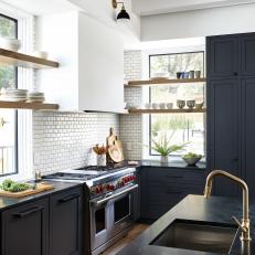 Black Cabinets and White Subway Tile Backsplash In Modern Kitchen