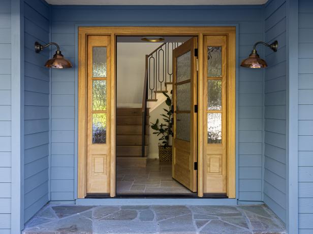 Entryway With Wood Front Door and Copper Sconces 
