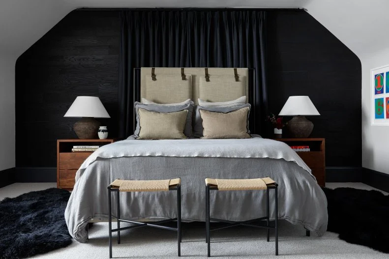 Upholstered Bed Against Black Accent Wall in Bedroom