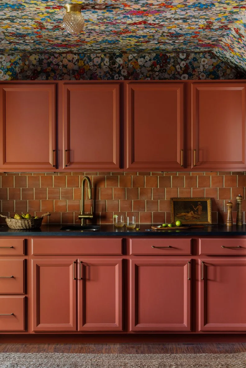 Orange-Pink Kitchen Cabinets With Brick Backsplash