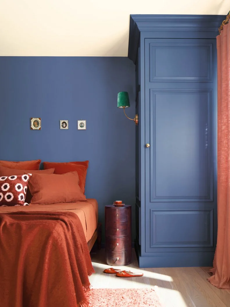 Blue-Purple Bedroom With Terracotta Bedding and Window Treatments