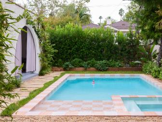 Backyard Pool With Coral and Pink Checkerboard Tile and Arched Pool House 