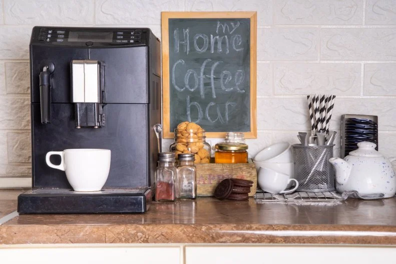 Home Coffee Station, hot drinks Bar. kitchen coffee corner with coffee machine, coffee beans, tea, sweets and toppings for drinks