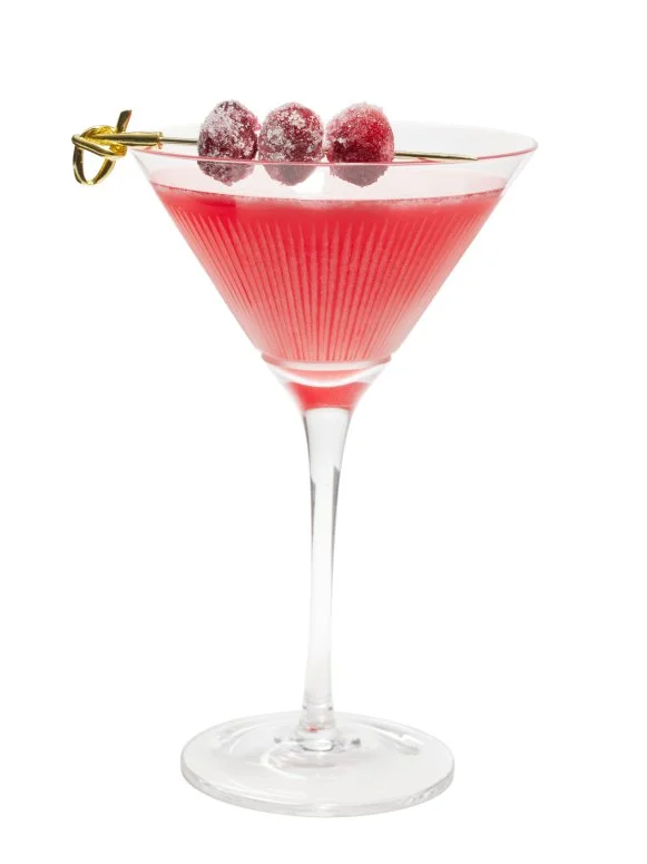 Cranberry Martini Garnished With Sugared Cranberries and a Gold Pick