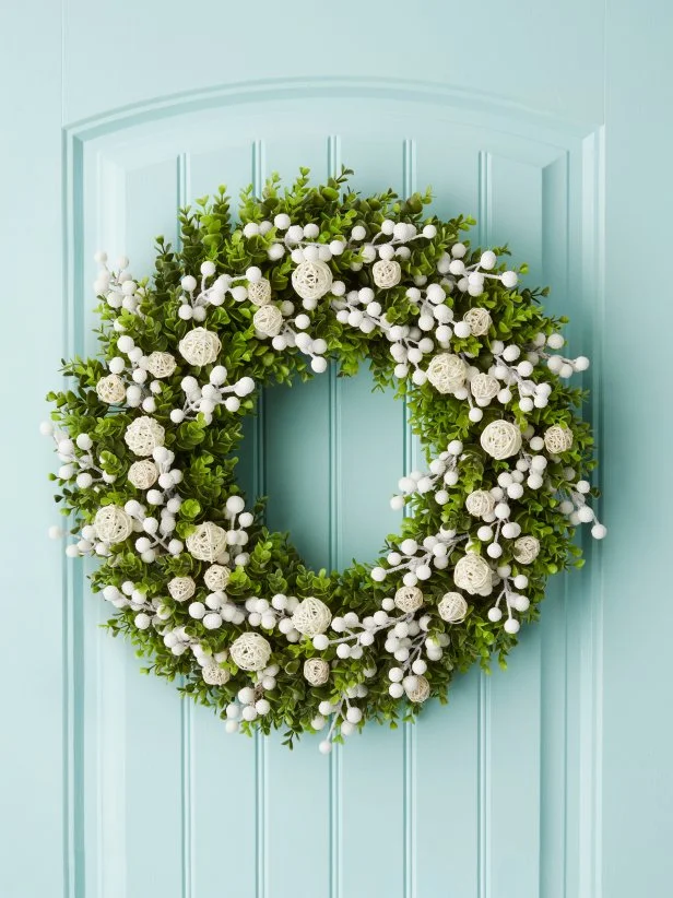 Faux Boxwood Wreath With White Berries on a Blue Door