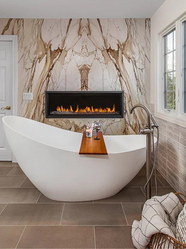 Modern, Spa-Inspired Bathroom With a Fireplace and Porcelain Wall