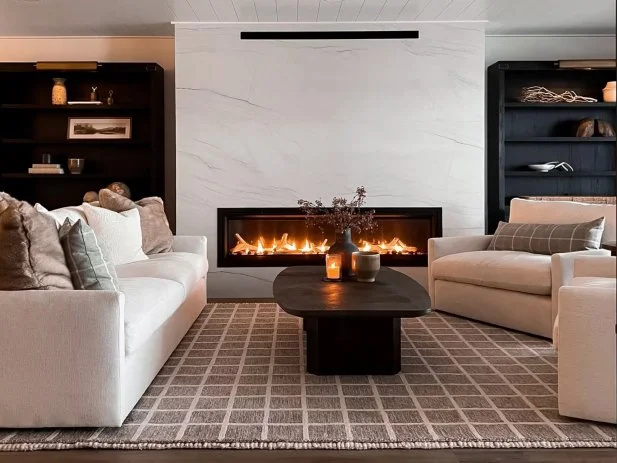 HGTV Magazine presents this modern cozy living room with neutral furniture and a gas fireplace with a porcelain slab surround.