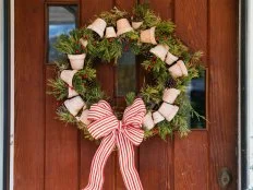 This flower pot wreath, customizable for any season, is beautiful when filled with fresh greenery and finished with a festive ribbon.