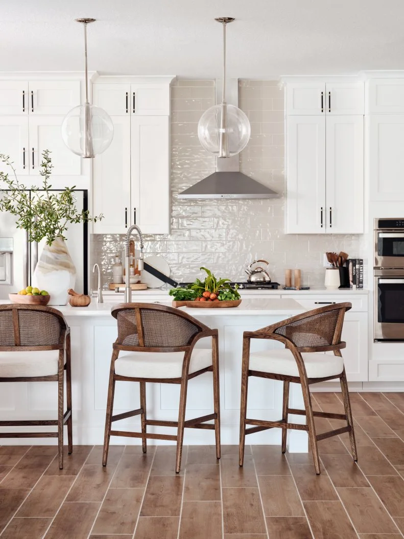 Neutral Kitchen With Globe Pendant Lights and Wooden Stools