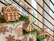 DIY Garland of Wooden Houses and Snowflakes on a Modern Staircase