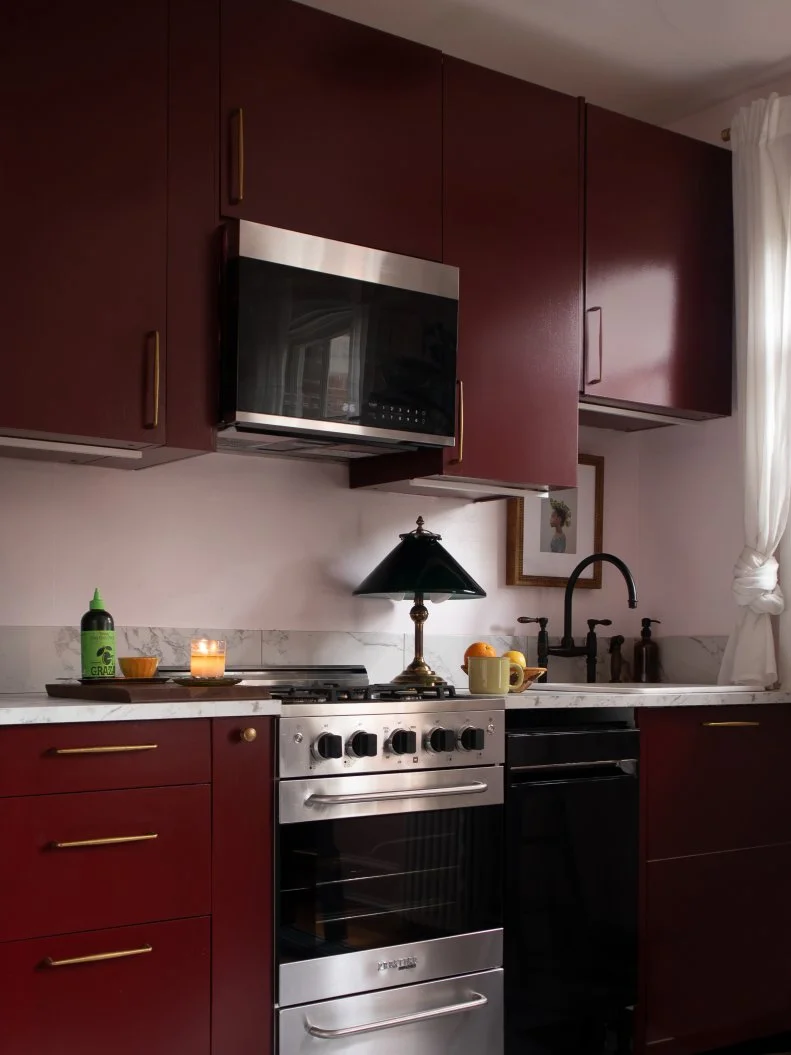 Minimal Kitchen With White Walls and Maroon Cabinets