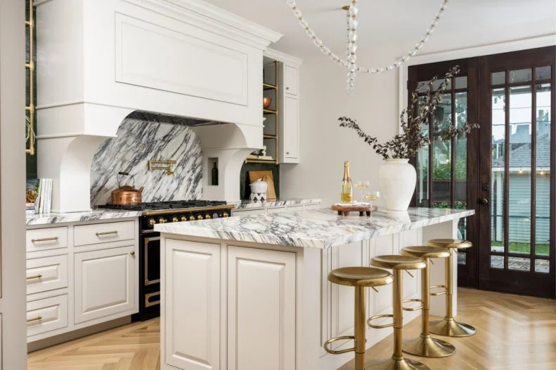 White Kitchen With Brass Stools