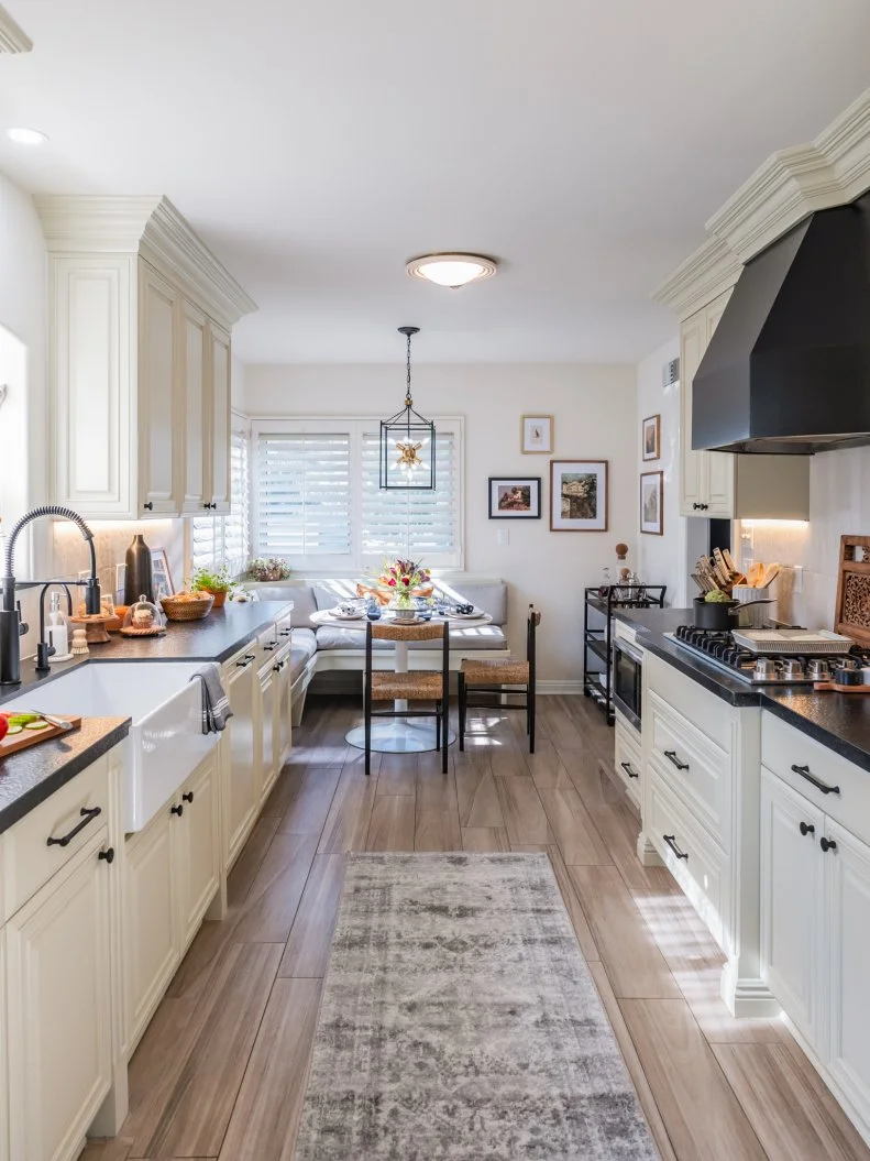 After - Drew Scott and Jonathan Scott brightened up the kitchen with a fresh coat of paint and updated the breakfast nook with new lighting and seating, as seen on Don't Hate Your House with the Property Brothers, Season 1.