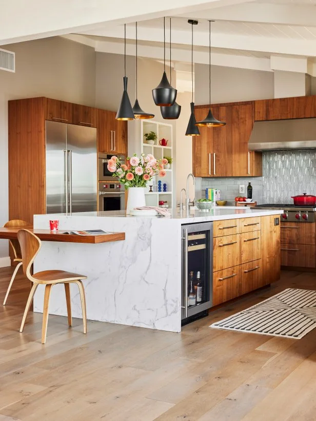 Cozy, Cool Kitchen With Marble Waterfall Island and Wood Cabinets