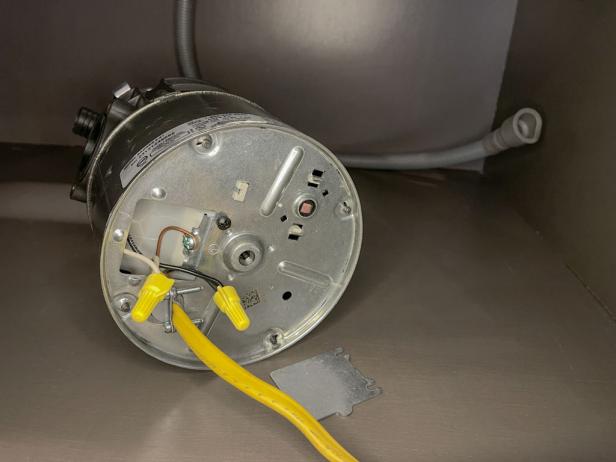 The next step in installing a garbage disposal is to connect the wires inside the electrical cover.