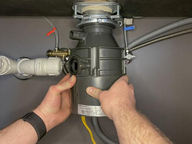 The next step in installing a garbage disposal is to mount the disposal on the drain flange.