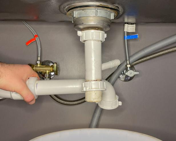 The next step in installing a garbage disposal is to unscrew the drain connections.
