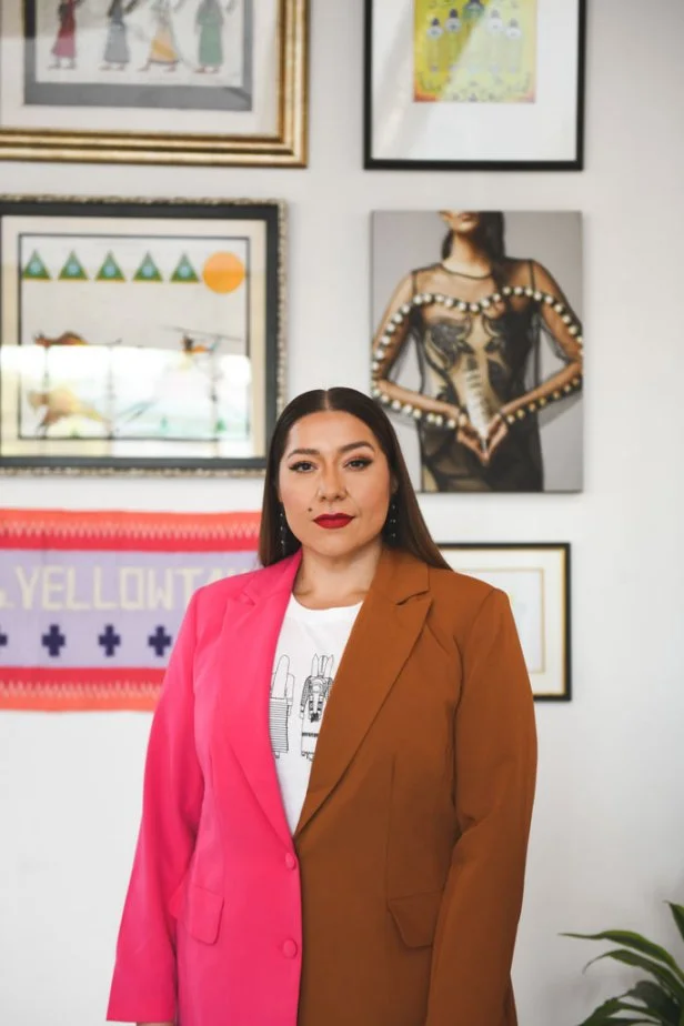 Woman Standing in Front of Gallery Art Wall