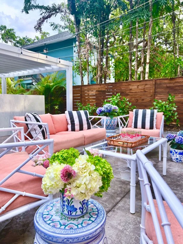 White Bamboo Patio Set With Pink Cushions and Striped Pillows