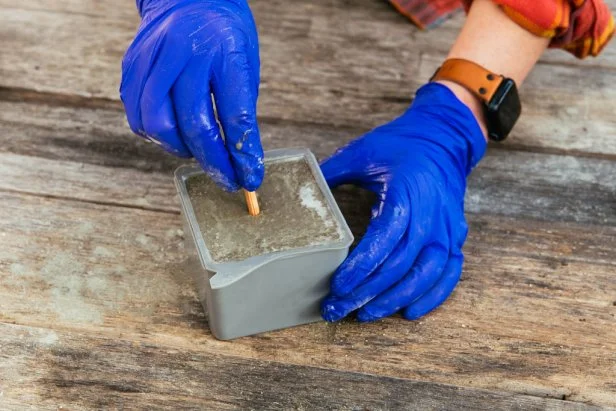 Insert a small wooden dowel into the center of the mold to make a drain hole.