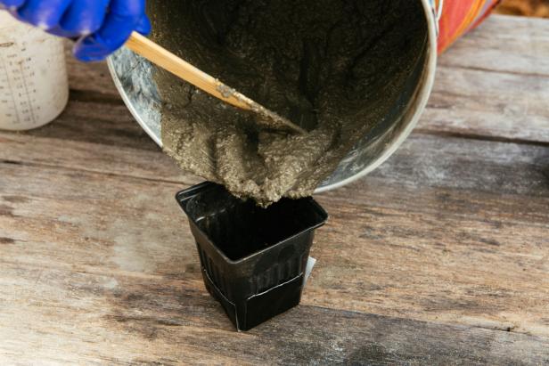 Pour concrete into the larger of your two containers until it is about 2/3 of the way full.