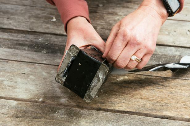 If you used upcycled containers, remove the tape and peel or cut the container away from the concrete.