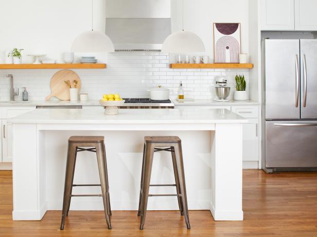 White Kitchen With Floating Wood Shelves and a White Island