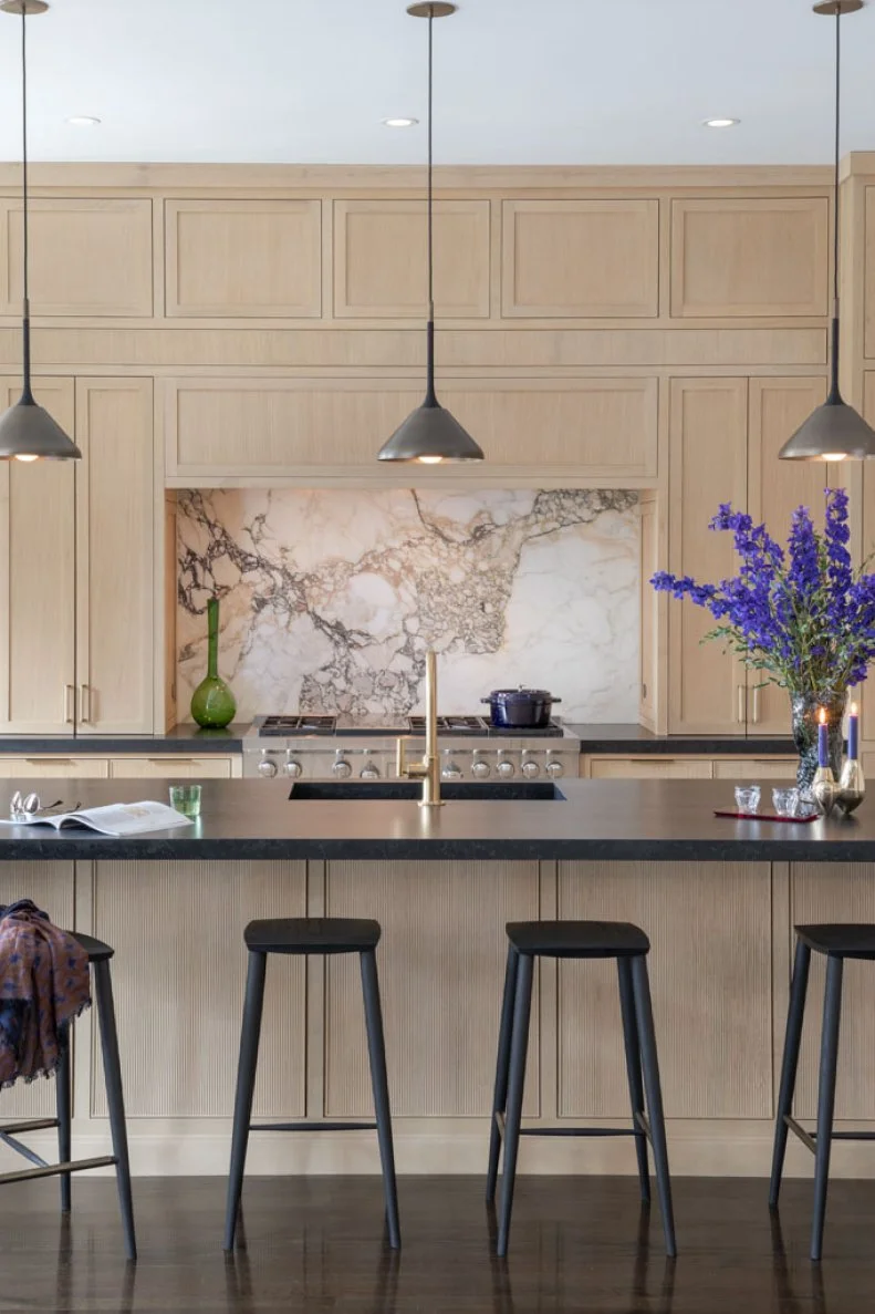 Four Barstools at Kitchen Island With Black Countertop
