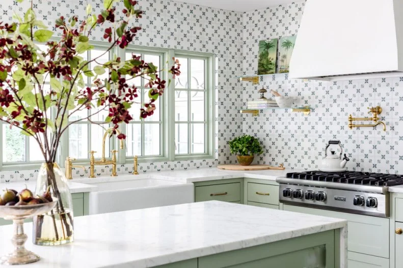 Bright Kitchen With Marble Countertops and Sage Green Cabinets