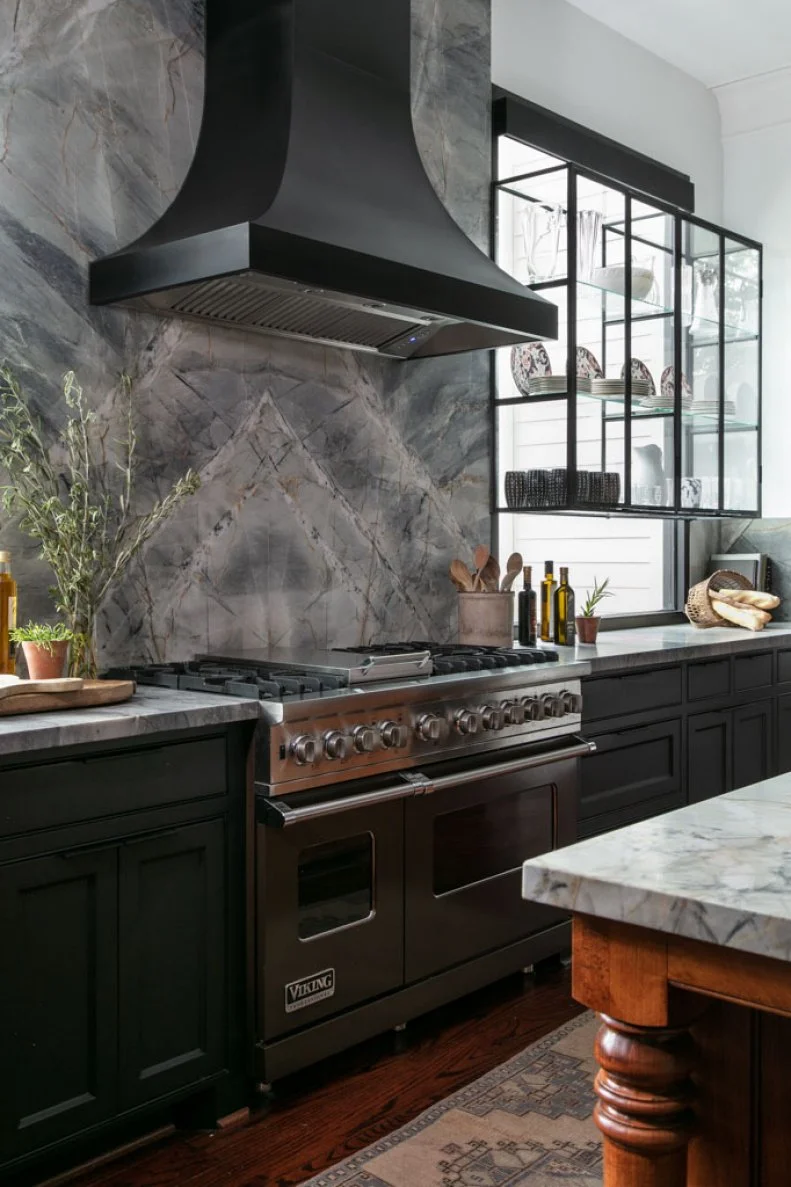 Black Range Hood Paired With Veined Marble Backsplash