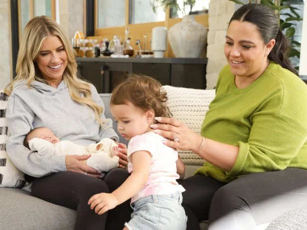 (From left to right) Christina hold's baby Jameson while older sister Jules climbs down with the help of mom Cassie.