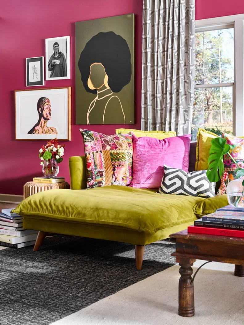 Green Sofa in Front of Gallery Wall in Pink Transitional Living Room