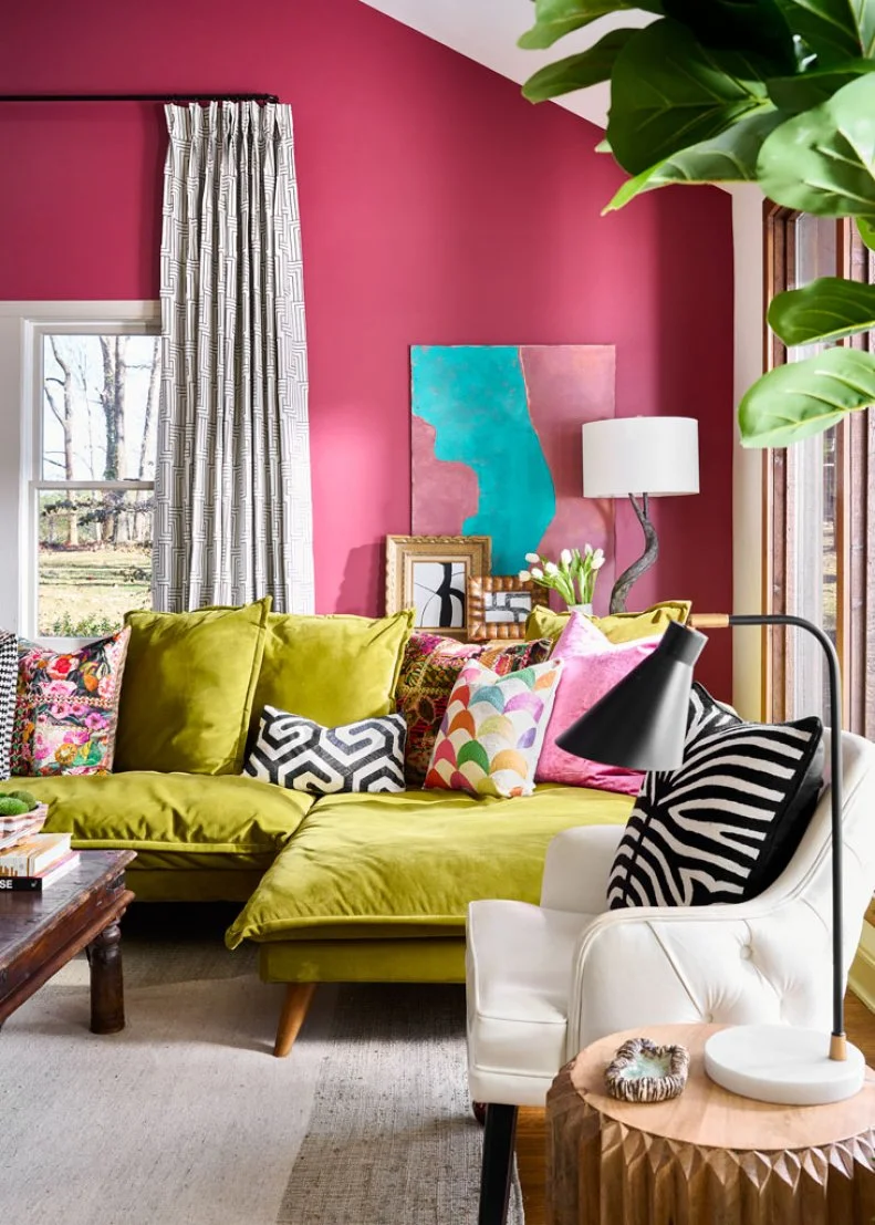 Green Sofa Topped With Pillows in Pink Transitional Living Room