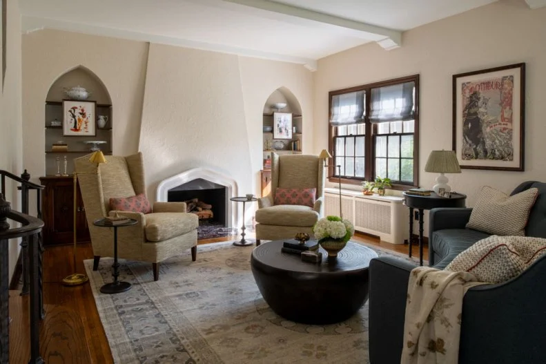 Bookshelves With Arched Tops in Neutral Transitional Living Room