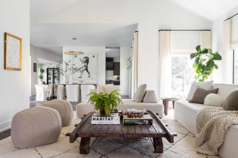 Sofas and Pouf Around Coffee Table in White Transitional Living Room