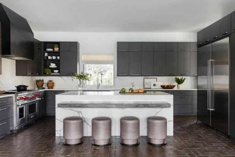 Four Short Stools Lined Up in Front of White Marble Kitchen Island