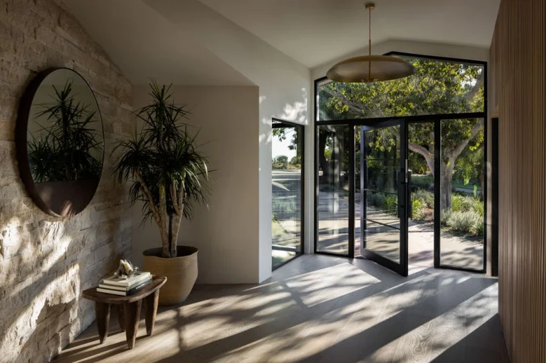 Glass Door Opens Into White Contemporary Foyer 