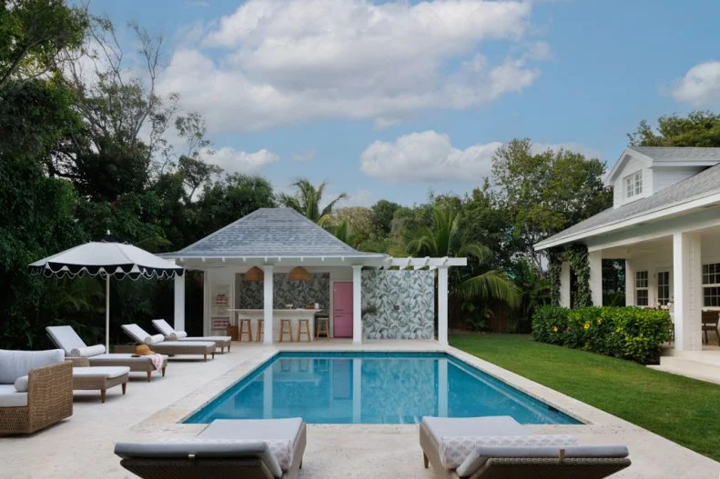Pair of Loungers at End of Pool Facing Cabana Bar
